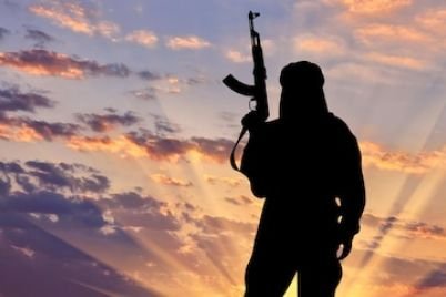 silhouette-terrorist-with-weapon-against-background-sunset_556258-1926.jpg